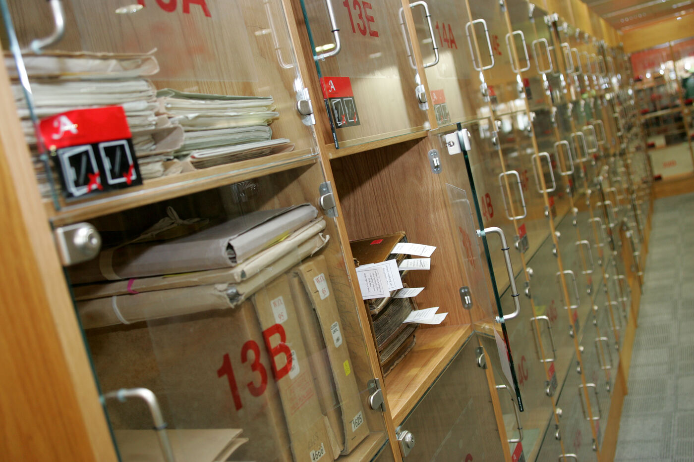 Archival documents carefully arranged and organized in a reading room, evoking the discipline of catalog documentation